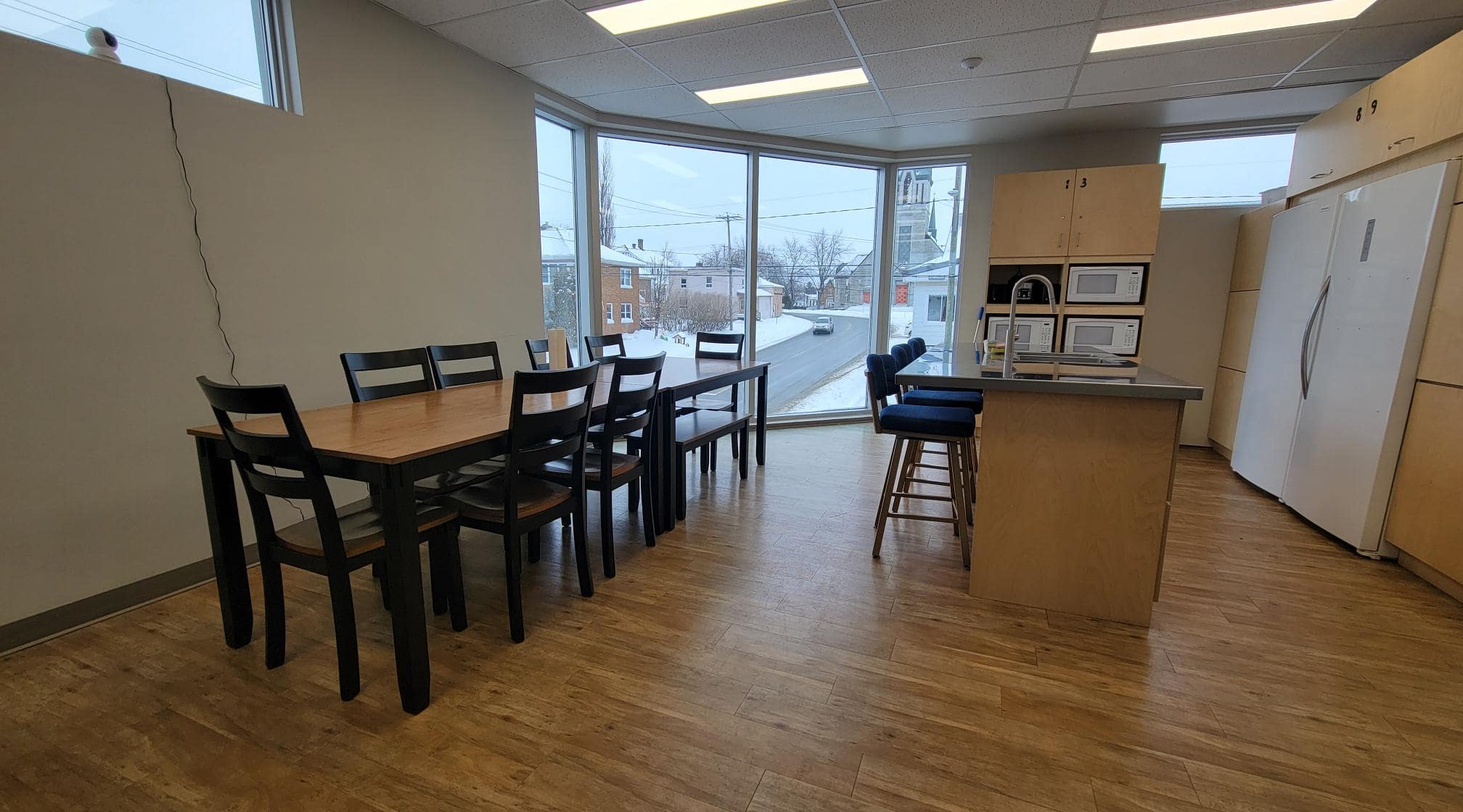 Photo d'un espace commun d'une résidence étudiante avec un comptoir de cuisine et une table à manger.