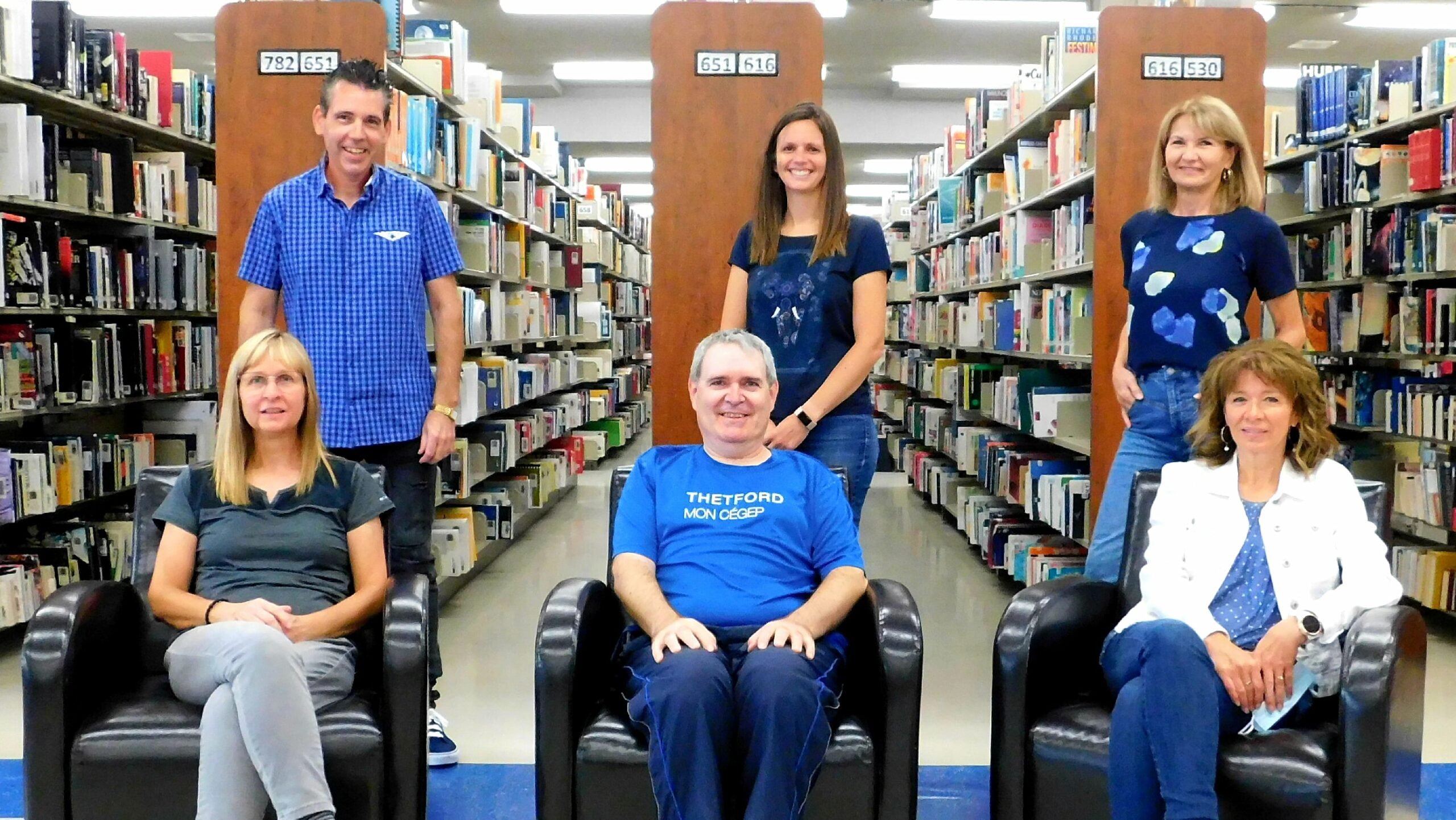 Groupe d'employés de la bibliothèque souriant à la caméra.